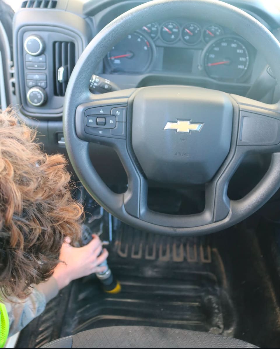 Steam billowing from a vehicle interior during a deep clean